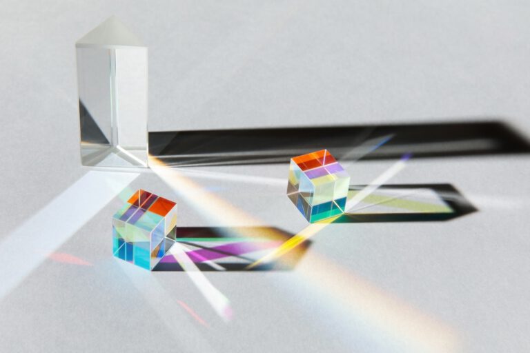 Glass geometric figures prisms with light diffraction and shadows